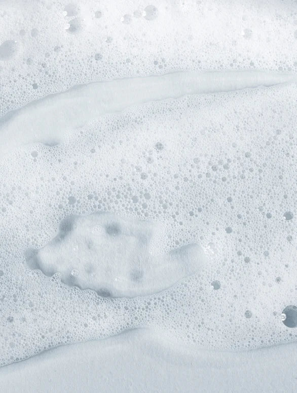 Close-up of soapy water with bubbles on a white background