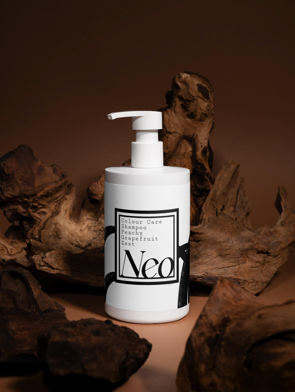 White bottle with pump labeled 'Neo' against a brown natural background